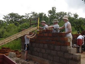 Joe with his students building a medical clinic in Lusyomo, Zambia.